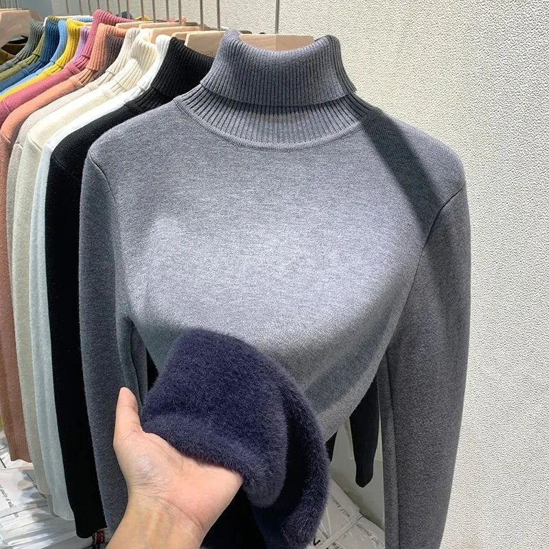 Charcoal gray turtleneck velvet sweater with ribbed collar and fuzzy sleeve cuffs