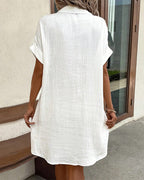 White collared mini button-front pocket dress, back view, short sleeves
