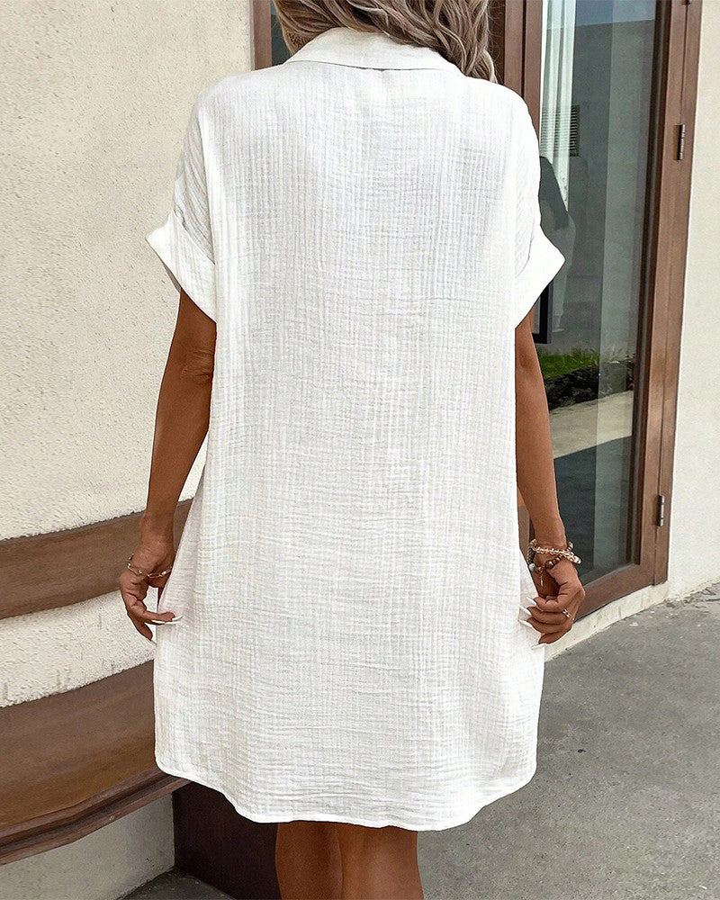 White collared mini button-front pocket dress, back view, short sleeves