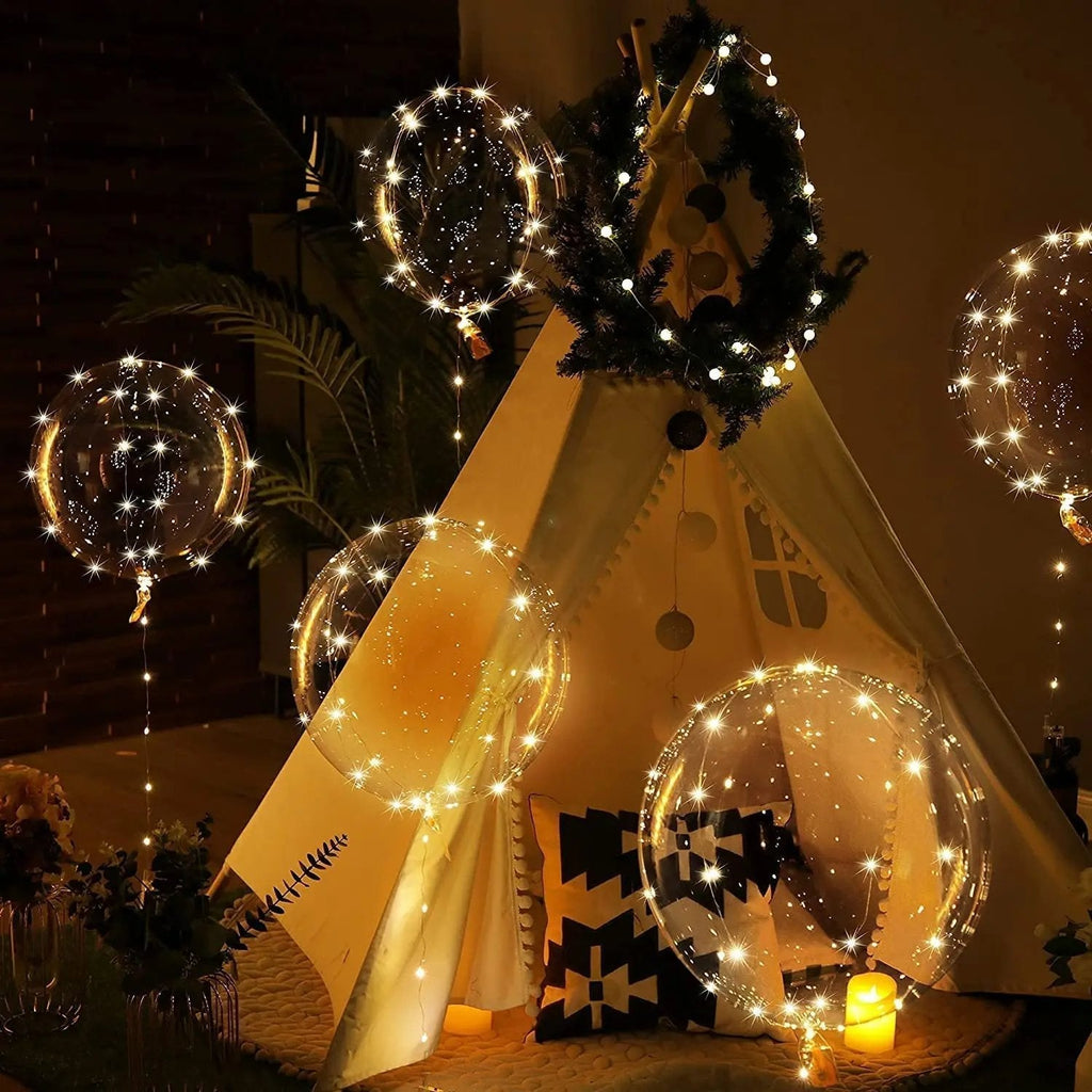 Warm white LED transparent balloons and light strings decorating a tipi-style tent