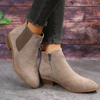 Light beige suede ankle boots with elastic side panels and low stacked heel