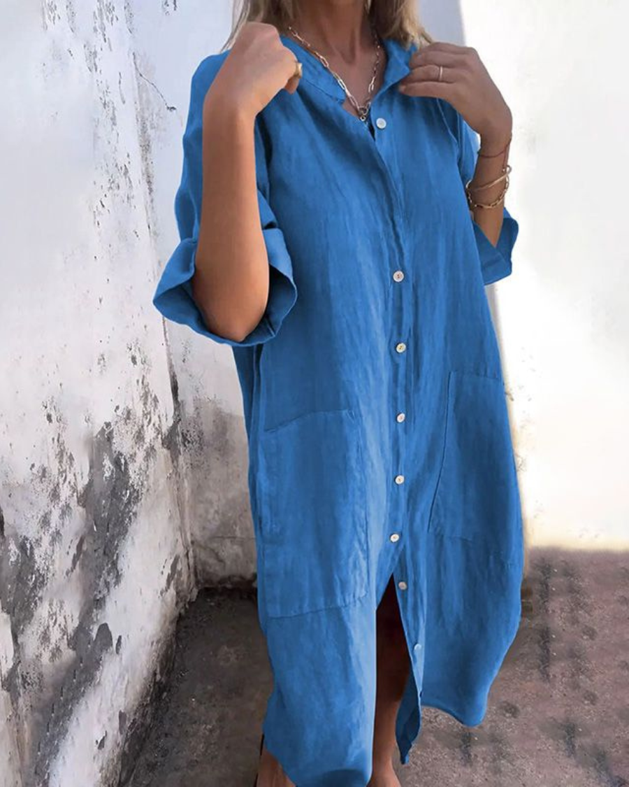 Blue button-front shirt dress with chest pocket and short sleeves, side slit hem