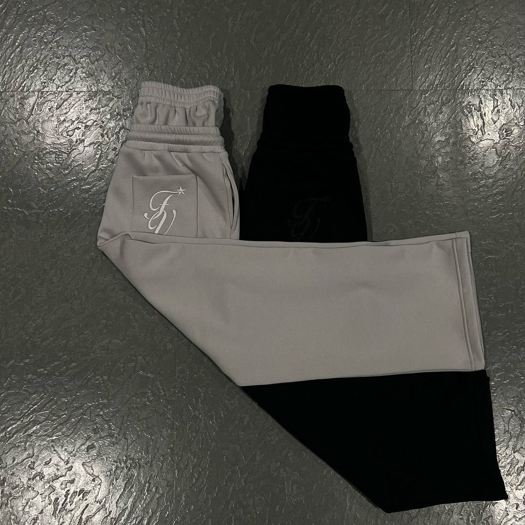 Unisex joggers laid flat: light gray and black pants with elastic drawstring waist