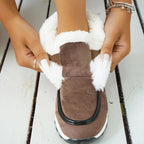 Women’s ankle platform boots in brown suede with white faux-fur lining and black trim.