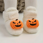 Children's Halloween slippers in white with orange jack-o'-lantern face front