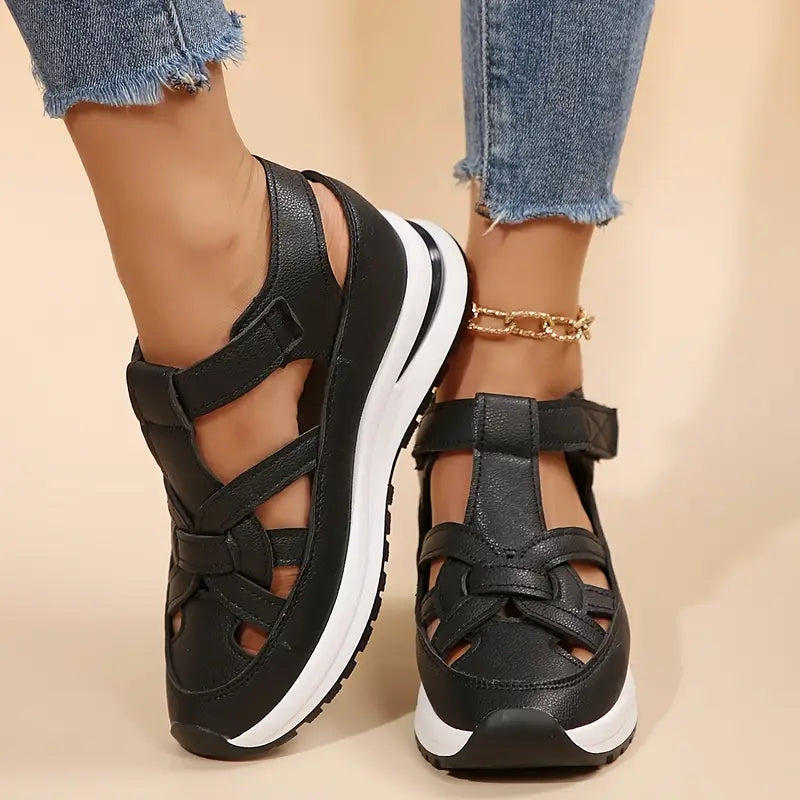 Black platform sandals with ankle strap and cross upper, rear view