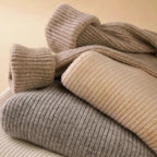 Folding close-up of ribbed knit turtleneck sweater in gray and beige tones