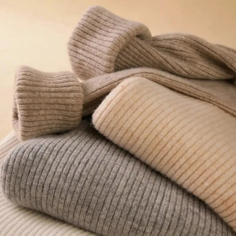 Folding close-up of ribbed knit turtleneck sweater in gray and beige tones