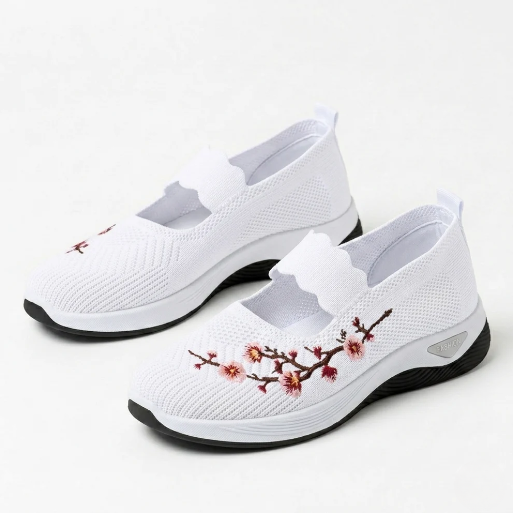 White knit slip-on sneakers with floral embroidery and cushioned black-trim sole