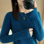 Blue crewneck pullover sweater with long sleeves and ribbed cuffs and hem