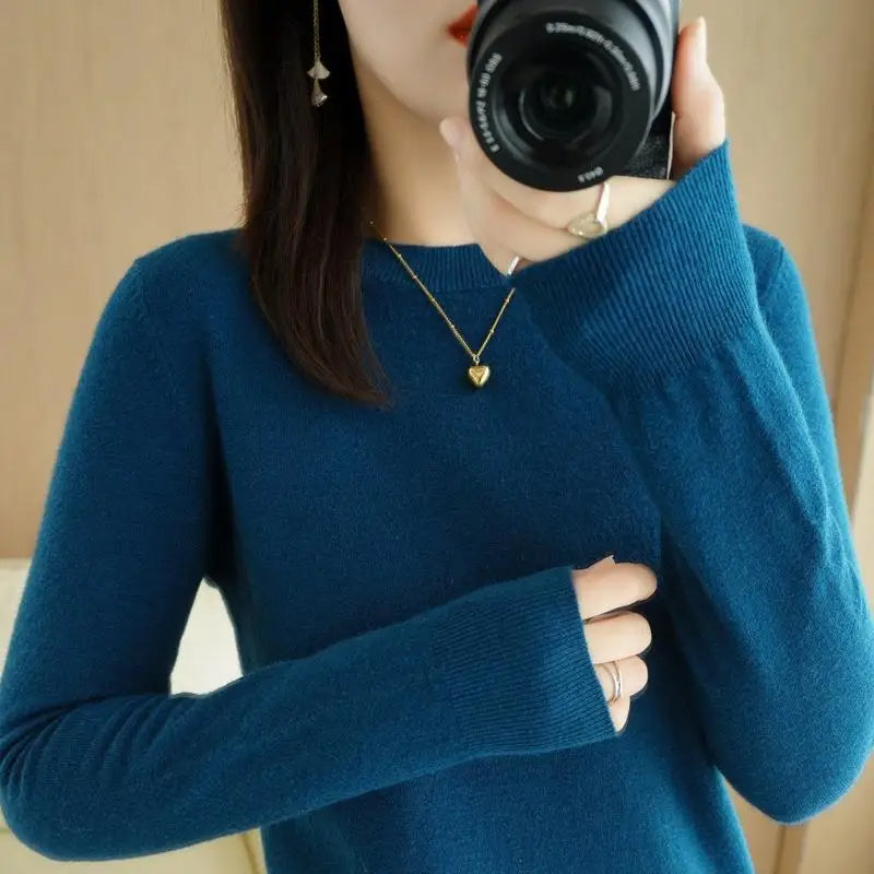 Blue crewneck pullover sweater with long sleeves and ribbed cuffs and hem
