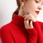 Red ribbed turtleneck sweater with raised collar and long sleeves