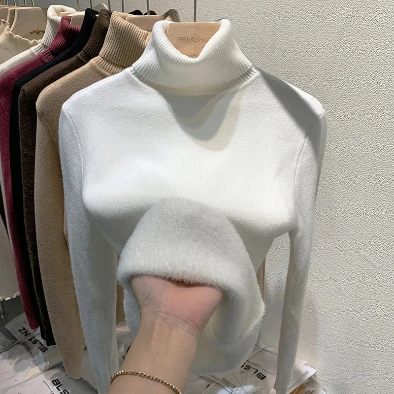 White turtleneck velvet sweater with ribbed collar and soft fuzzy sleeve detail