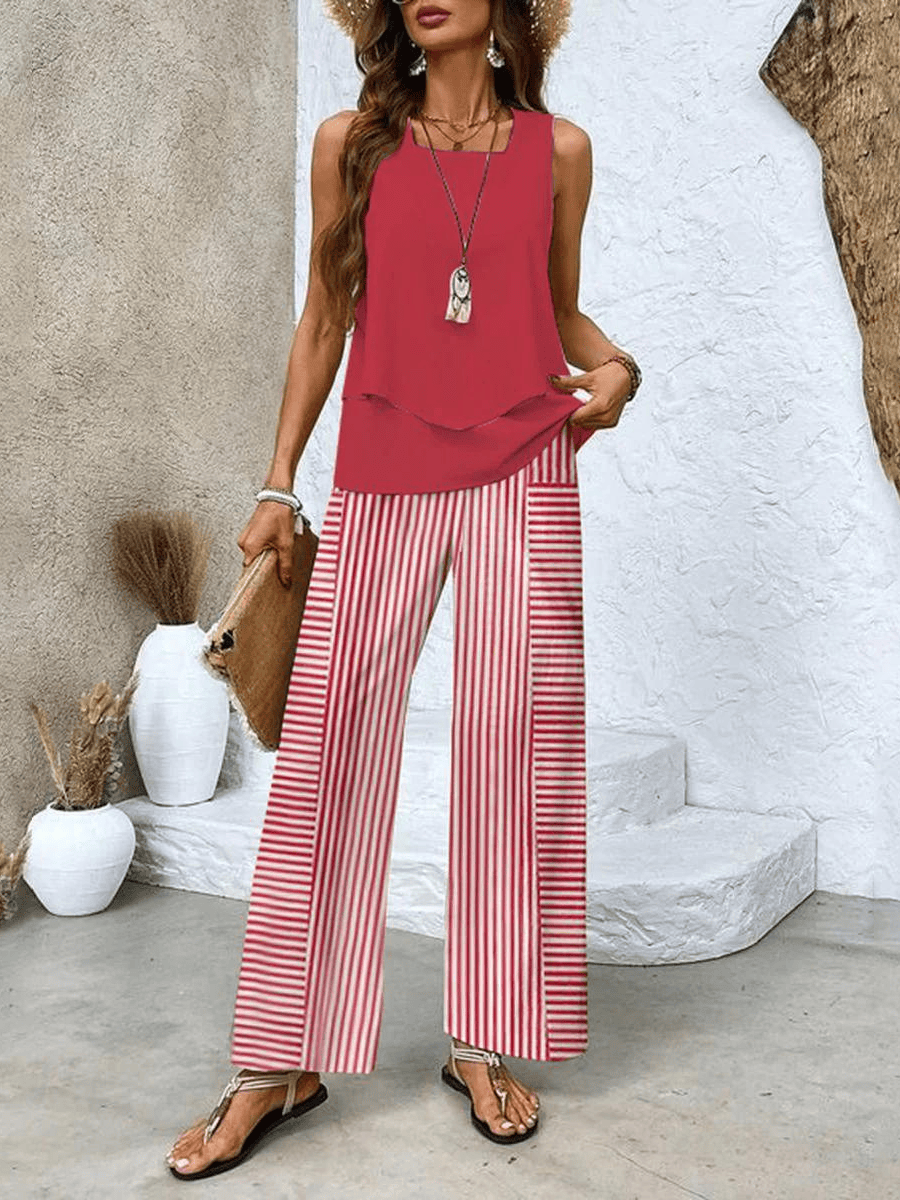 Red sleeveless blouse with layered hem and wide-leg trousers with red-and-white stripes