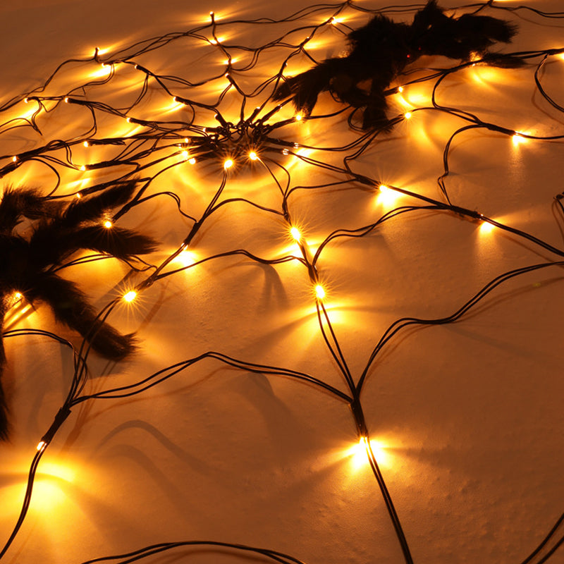 Close-up of warm LED bulbs on a Halloween spiderweb light strand