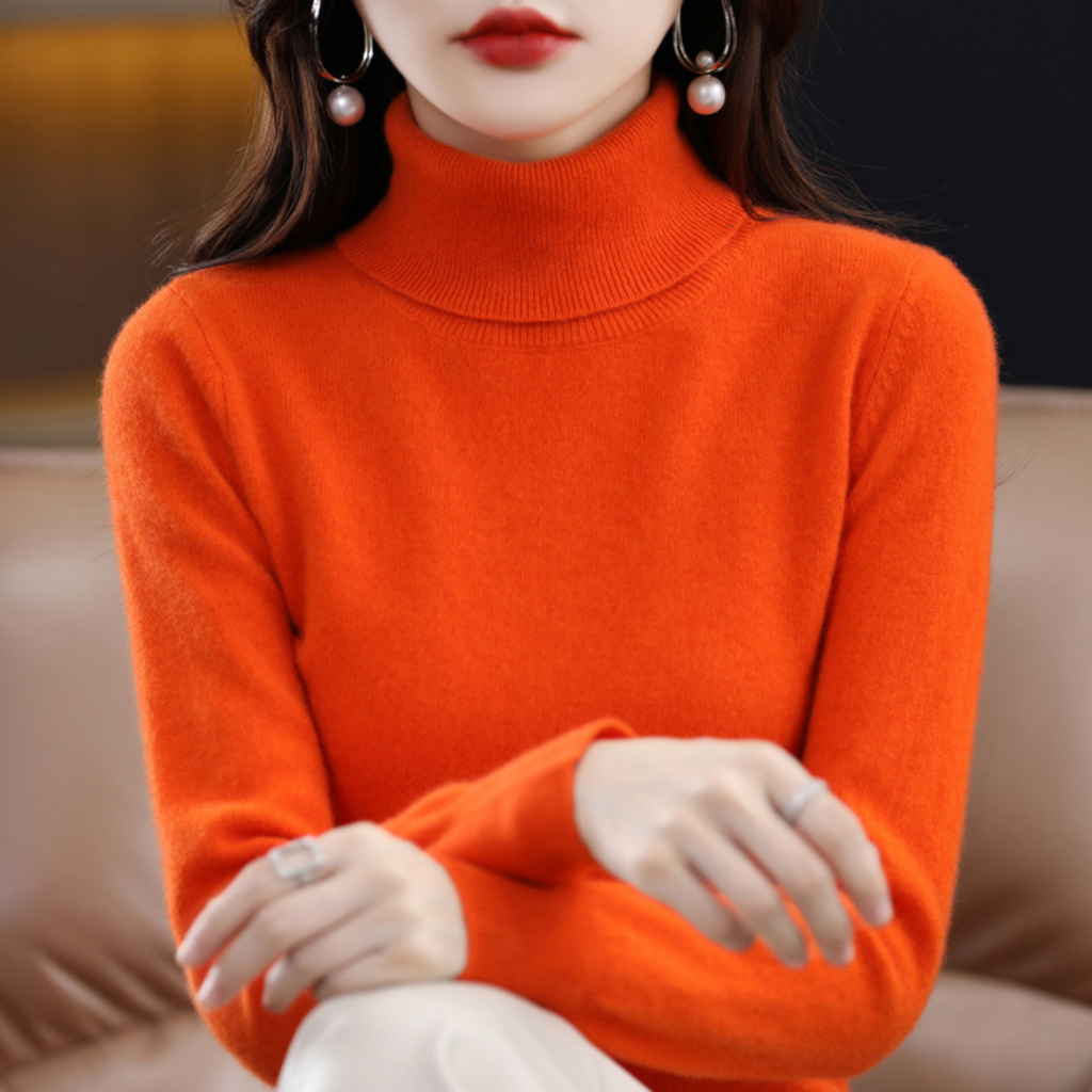 Women's cashmere turtleneck sweater in orange, long sleeves, ribbed collar and cuffs.