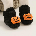 Children's Halloween slippers in black with orange jack-o'-lantern face applique