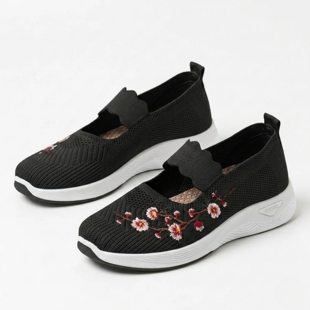 Black knit slip-on sneakers with floral embroidery and cushioned white sole