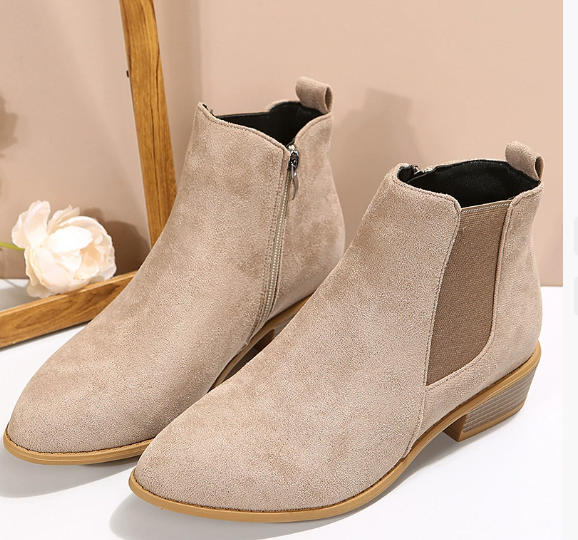 Beige suede ankle boots with elastic side panels and low stacked heel, studio pair