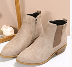 Beige suede ankle boots with elastic side panels and low stacked heel, studio pair