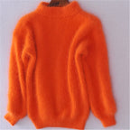 Bright orange loose knit wool sweater with high neck and long wide sleeves