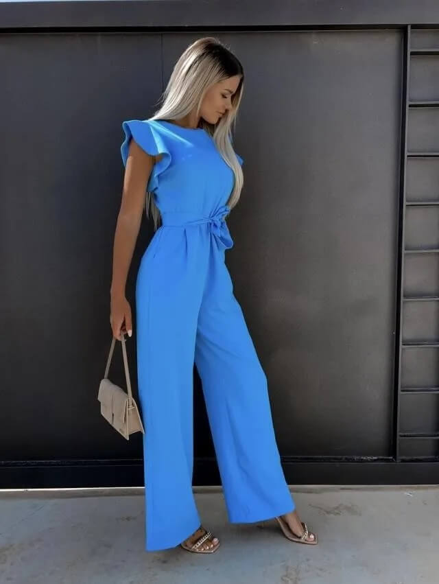 Blue wide-leg jumpsuit with flutter sleeves and waist-tie belt, side view