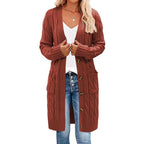 Rust red long knitted vest with button-front and cable texture side pockets.