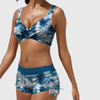 Blue tie-dye bikini set with V-neck padded top and ruched drawstring swim shorts