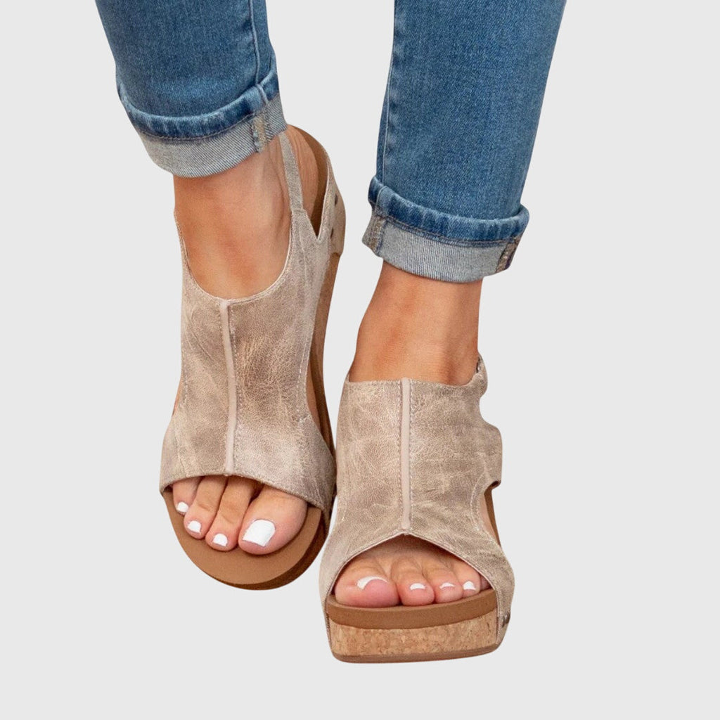 Beige open-toe wedge sandals with cushioned sole and ankle strap