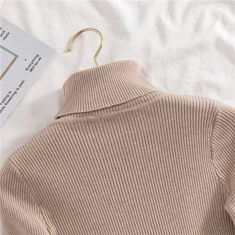 Beige ribbed knit turtleneck sweater, back view