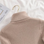 Beige ribbed knit turtleneck sweater, back view