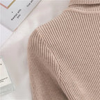 Beige ribbed knit turtleneck sleeve seam and knit texture close-up