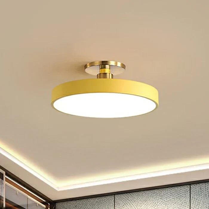 Round flush-mount LED ceiling lamp, yellow shade with gold base and white glow