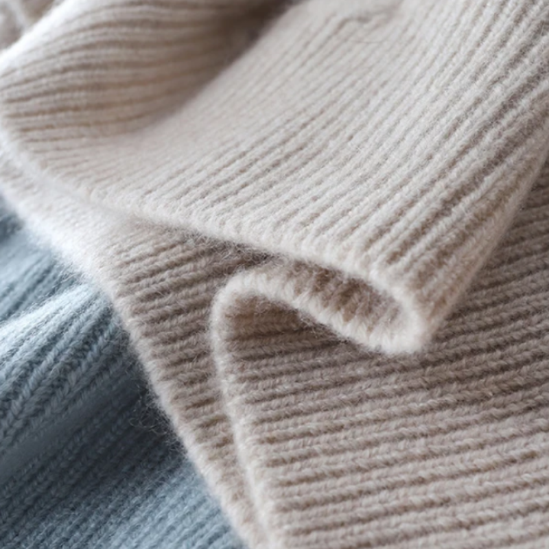 Beige cashmere turtleneck sweater, ribbed knit cuff and sleeve texture close-up