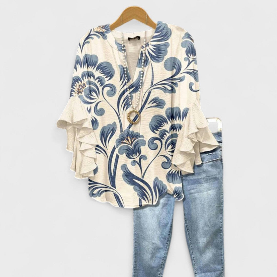 Women’s v-neck blouse with ruffle sleeves, cream base with blue swirl floral print