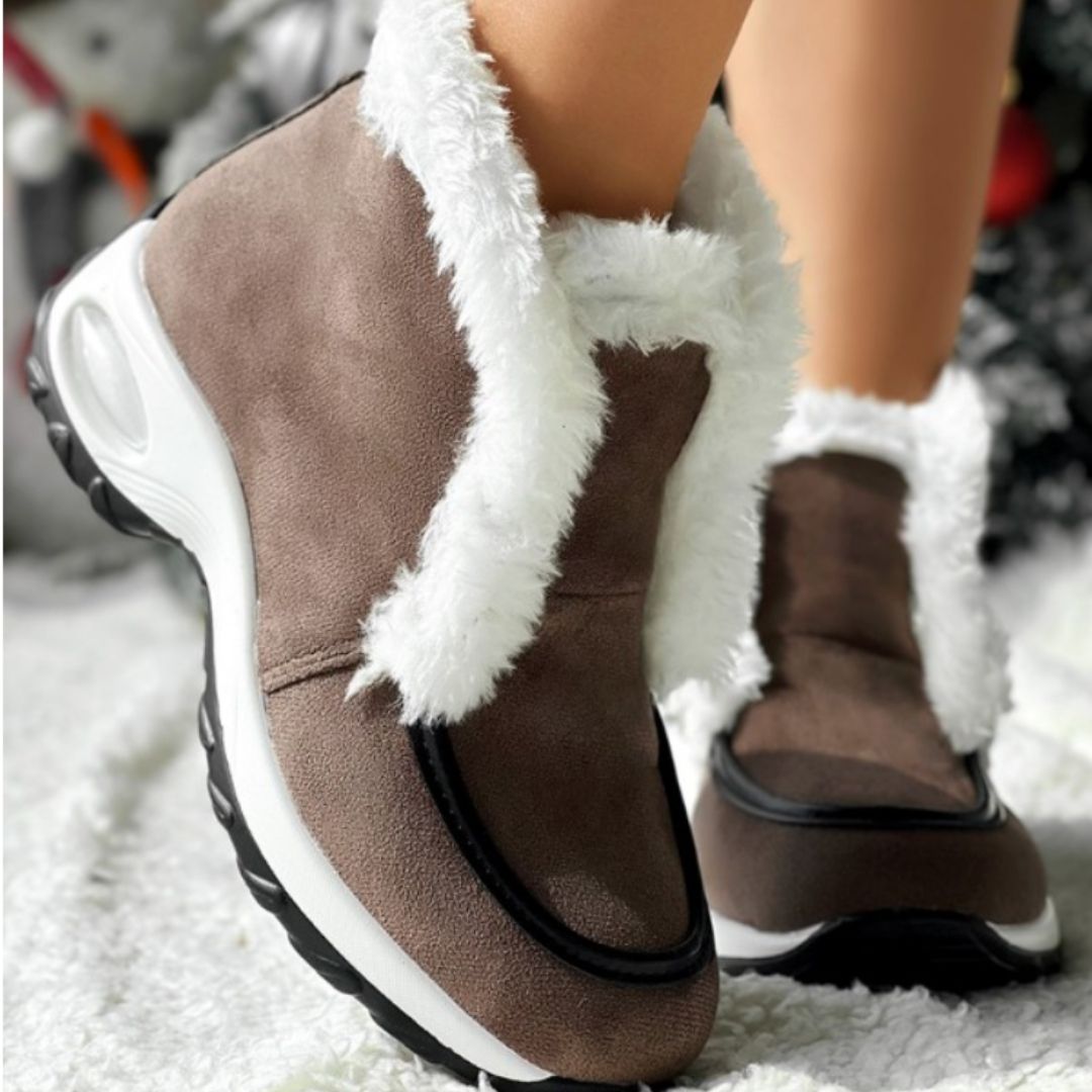 Women’s ankle platform boots in brown suede with white faux-fur cuff and black platform sole.