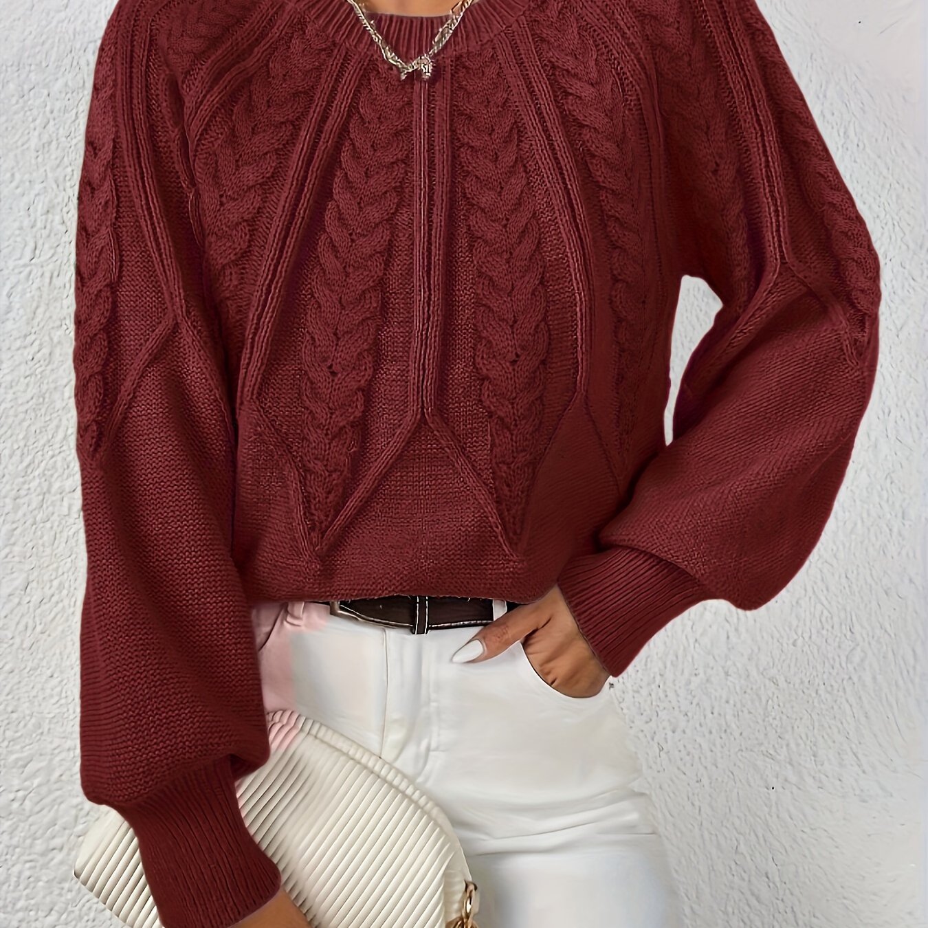 Women’s cable knit sweater with lantern sleeves, dark red, textured cable knit front.