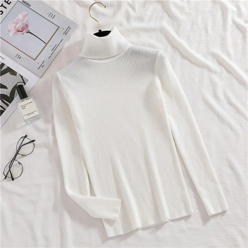 White ribbed knit turtleneck sweater with long sleeves, laid flat