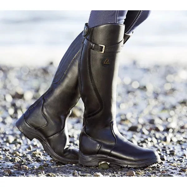 Black knee-high waterproof boots with side panels, buckle strap, and grippy sole