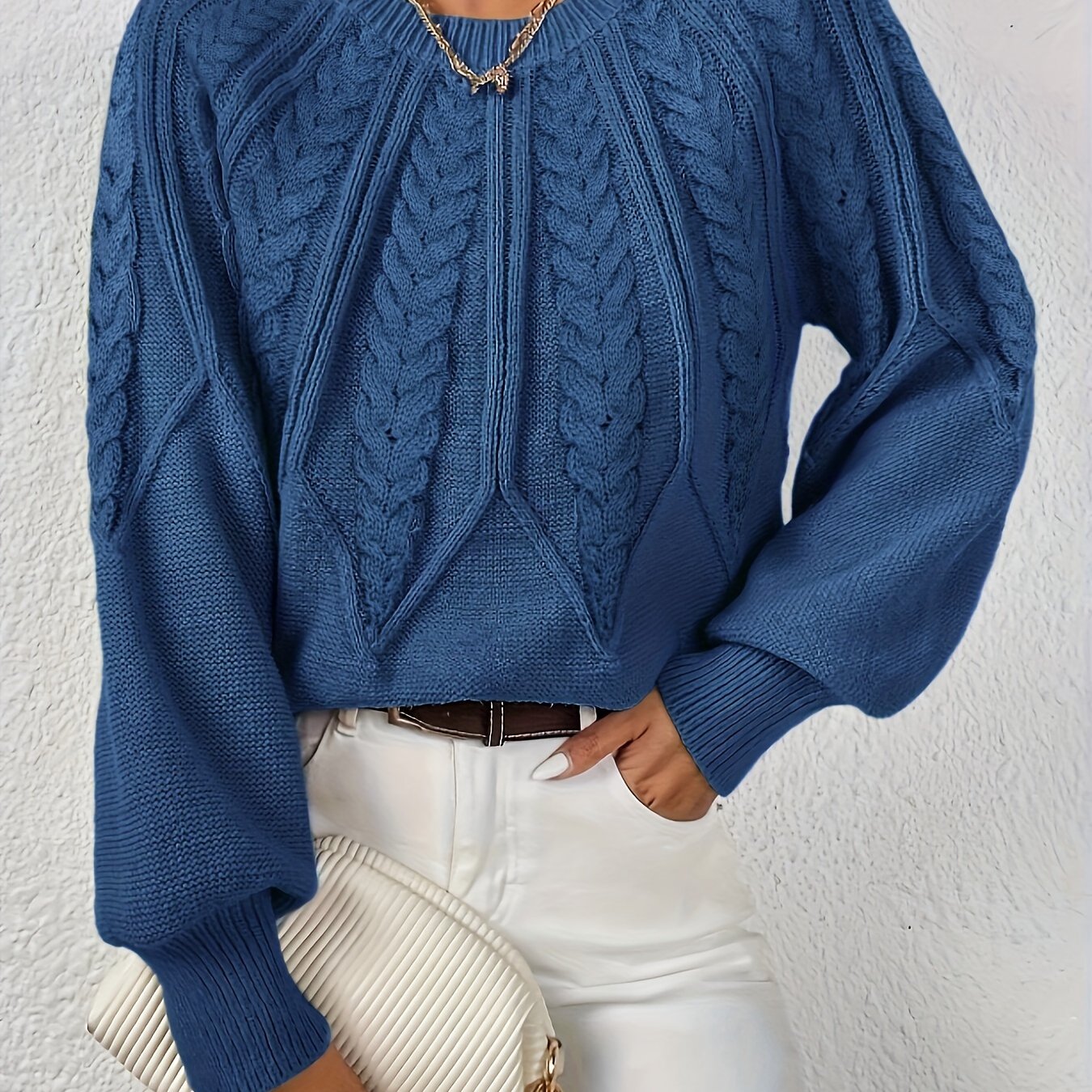 Women’s cable knit sweater with lantern sleeves, dark blue, vertical cable knit details.