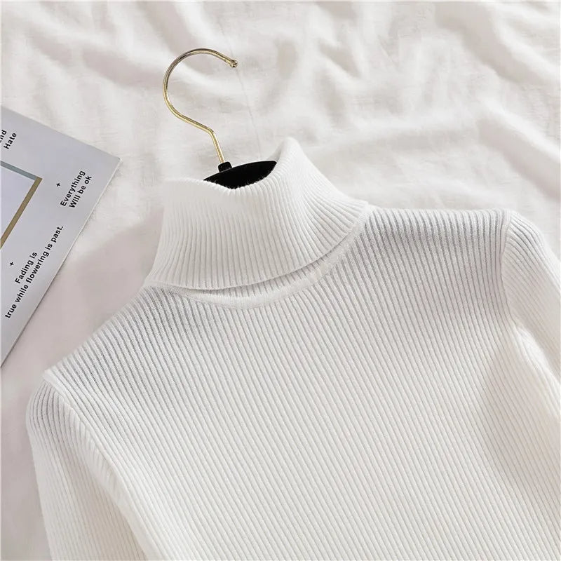 White ribbed knit turtleneck sweater detail with high collar and texture