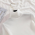 White ribbed knit turtleneck sweater detail with high collar and texture