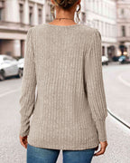 Knitted women’s top with buttons, long back view, crew-like neckline, light brown rib knit