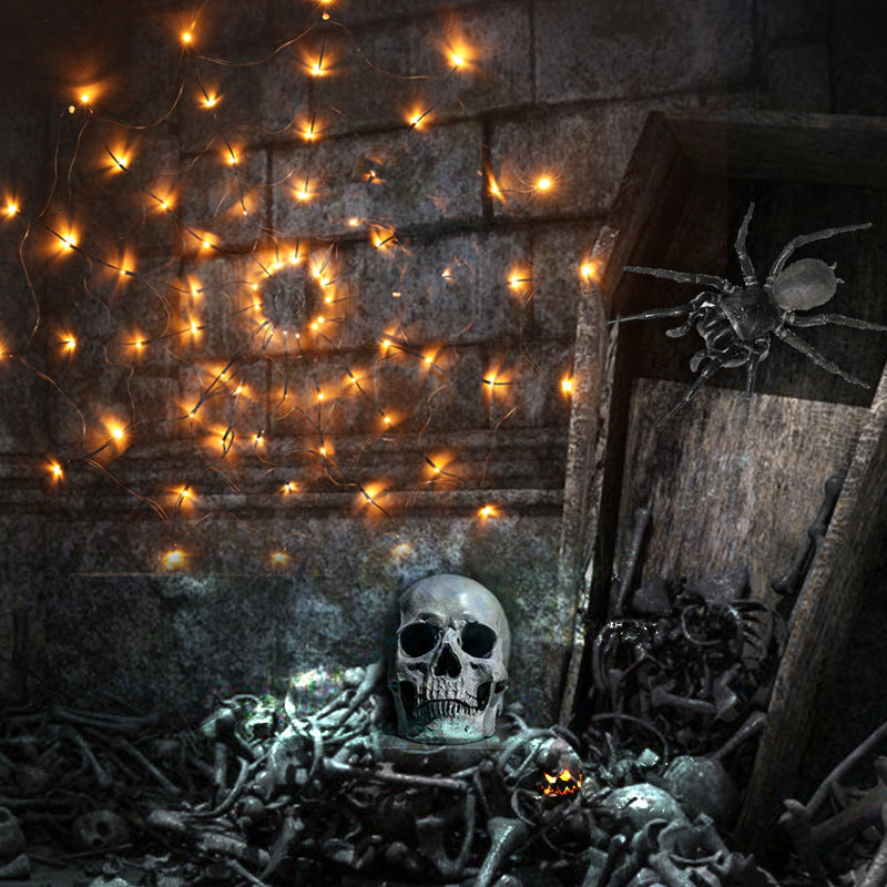 Warm LED spiderweb light net with glowing bulbs and hanging black spider web decor