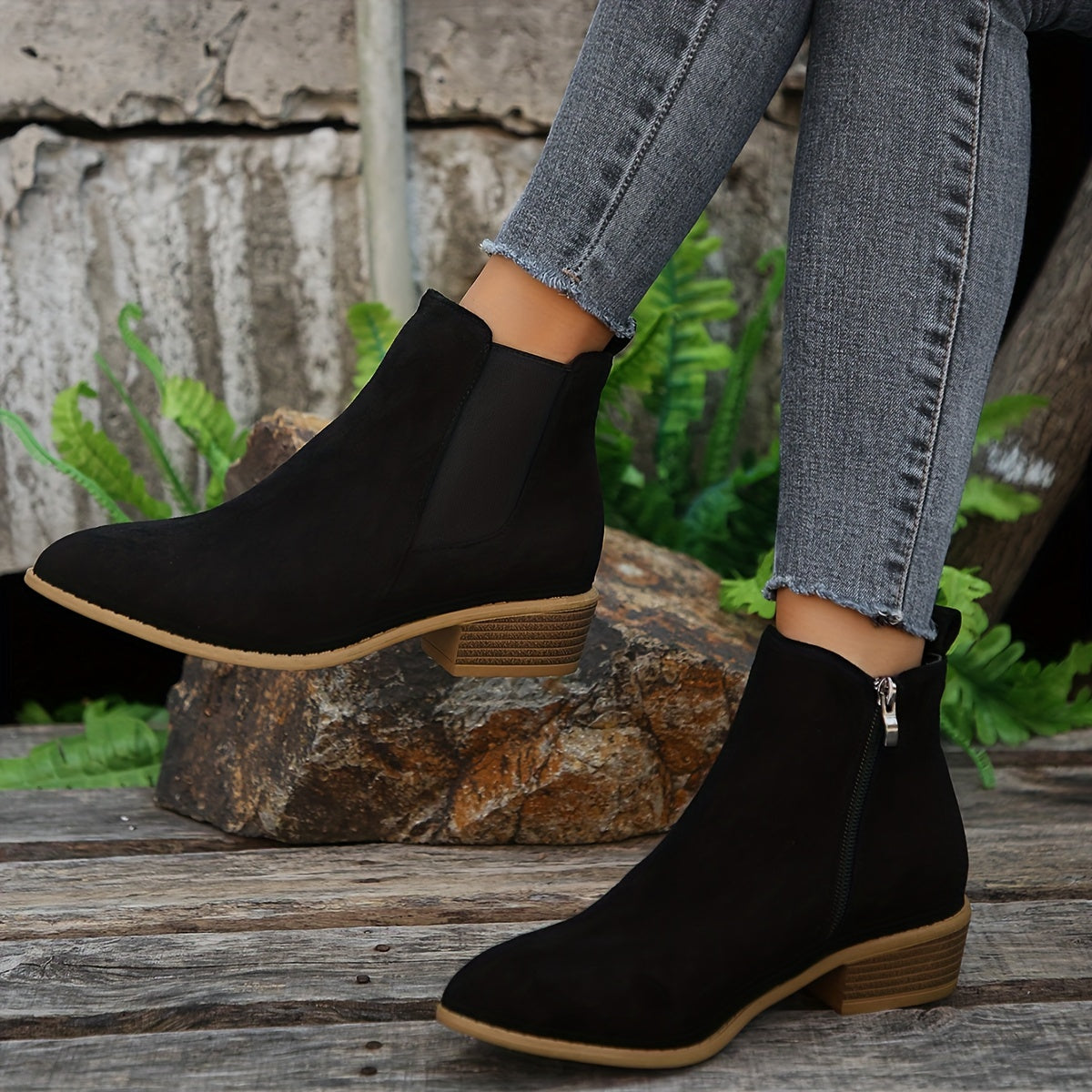Black suede ankle boots with elastic side panels and low stacked heel, side view
