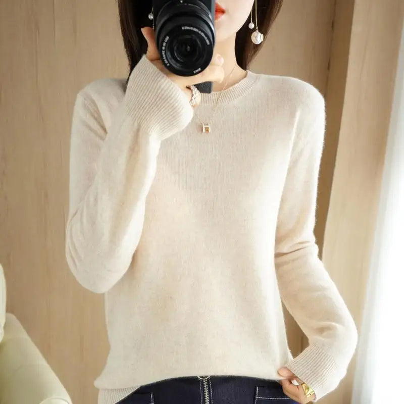 Cream crewneck pullover sweater with long sleeves and ribbed cuffs and hem