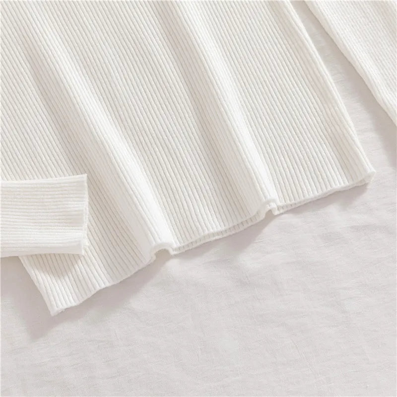 White ribbed knit turtleneck sweater sleeve cuff and straight hem