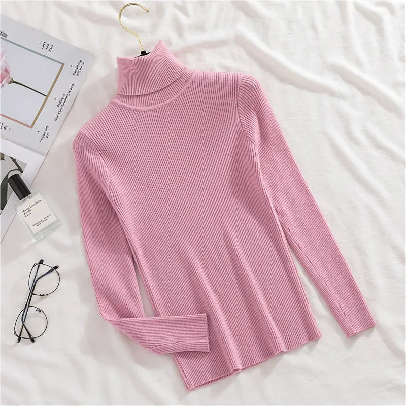Pink ribbed knit turtleneck sweater with long sleeves and folded cuff