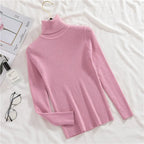 Pink ribbed knit turtleneck sweater with long sleeves and folded cuff