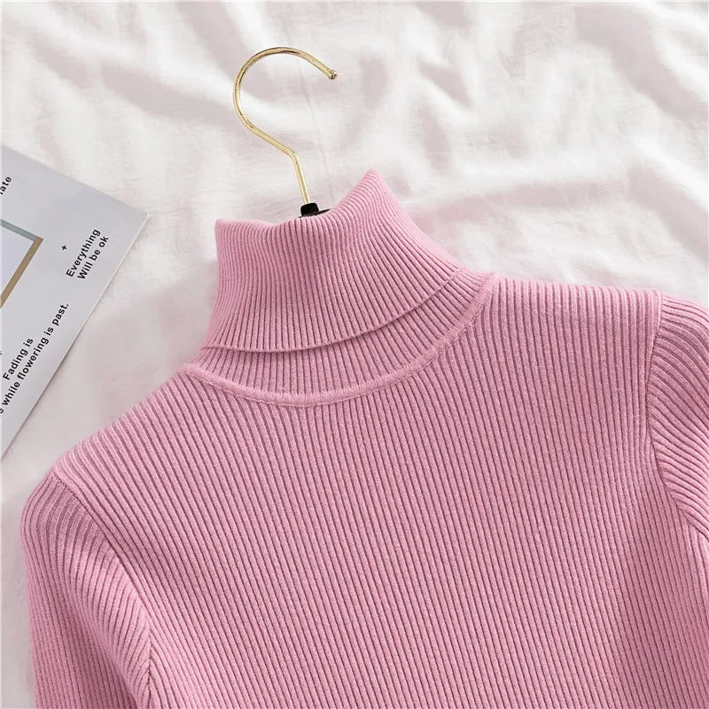 Pink ribbed knit turtleneck sweater close-up of high collar and knit texture
